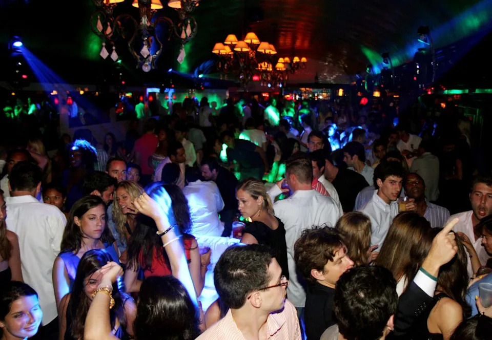 A crowded night at Lily Pond represents a time before nightlife in the Hamptons fell flat. WireImage