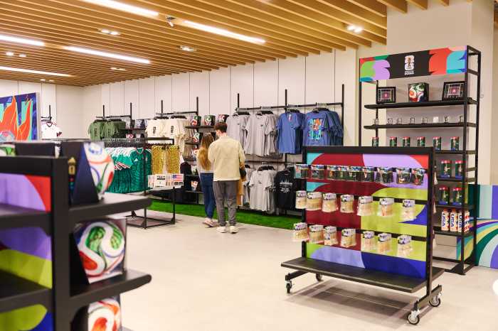 shirts and soccer balls on display in a retail shop