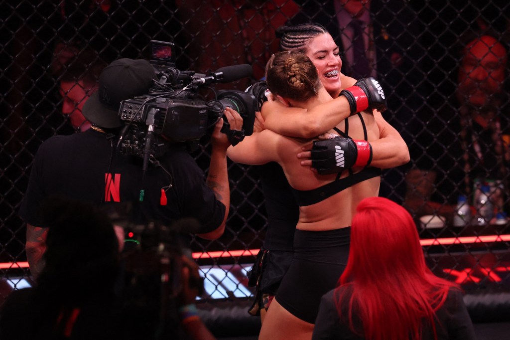 Ronda Rousey hugs Gina Carano after defeating her in an MMA match.