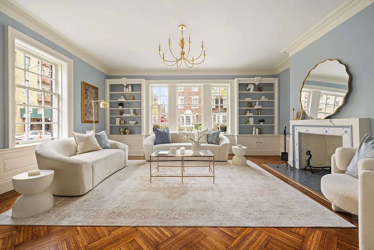 living room with blue walls, a mantel
