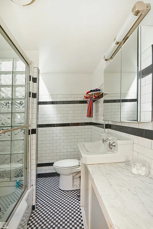 bathroom with shower, black and white tile