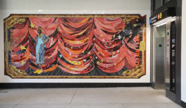 large wall mosaic near an elevator