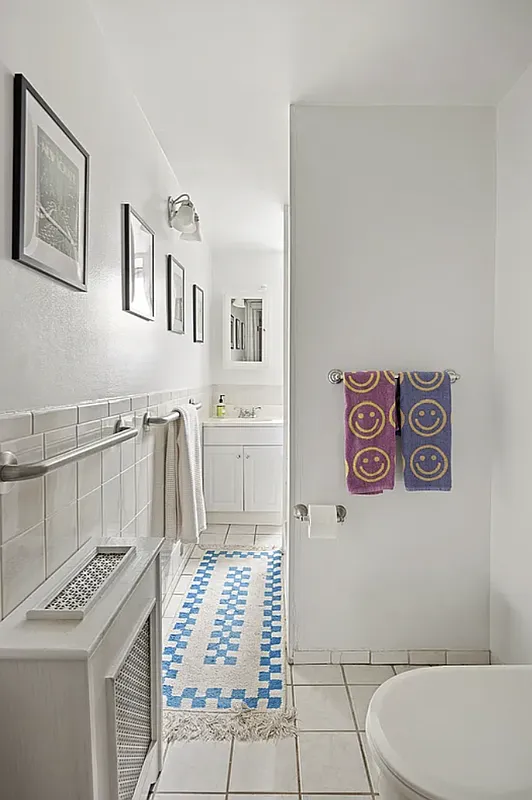 bathroom with white fixtures and tiles