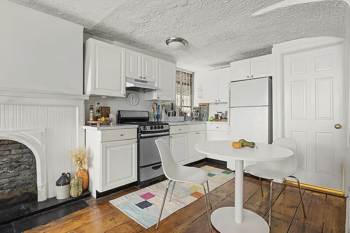 open plan kitchen with white cabinets