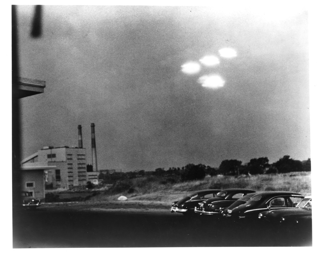 Four brightly glowing UFOs over a parking lot in Salem, Massachusetts.