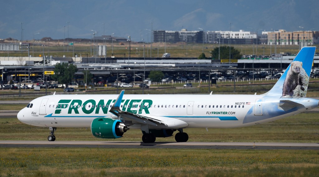 A Frontier Airlines flight waits on a runway for take-off at Denver International Airport on Sept. 1, 2023.