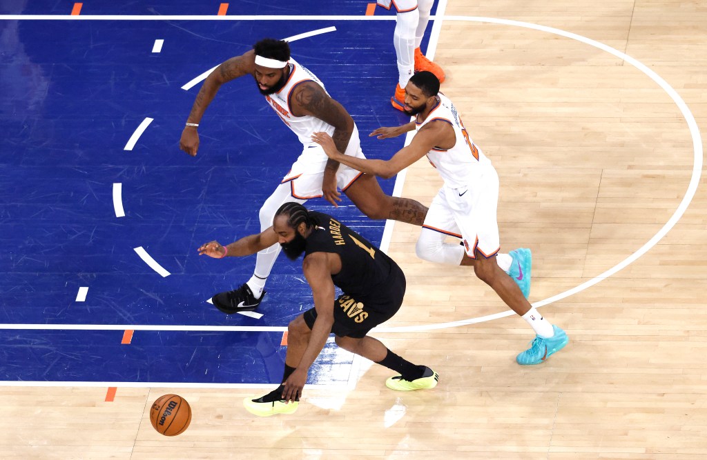 Cleveland Cavaliers guard James Harden (1), New York Knicks center Mitchell Robinson (23), and New York Knicks guard Mikal Bridges (25) chase a loose basketball on the court.