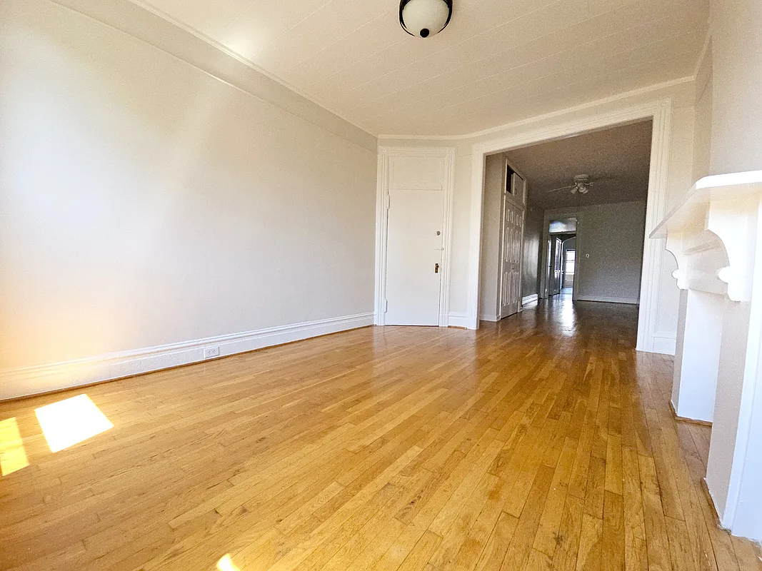 room with wood floor, mantel