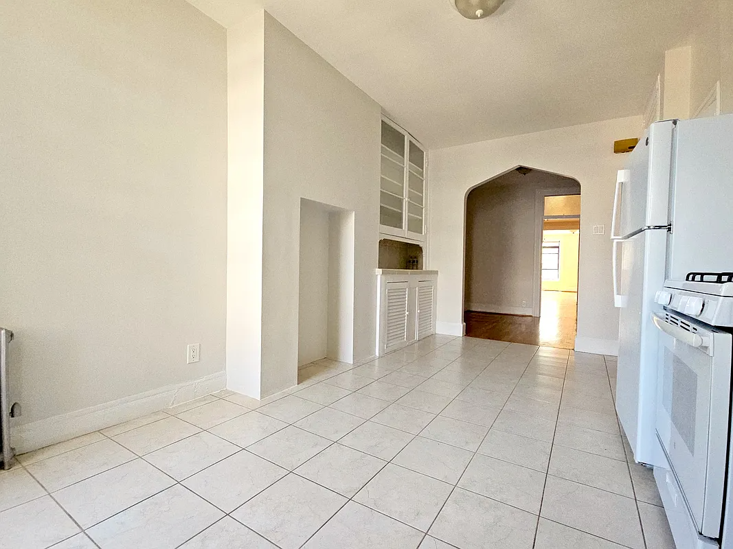 kitchen with built-in cabinet, white floor tiles