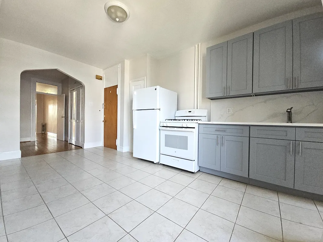 kitchen with tile floor, white appliances