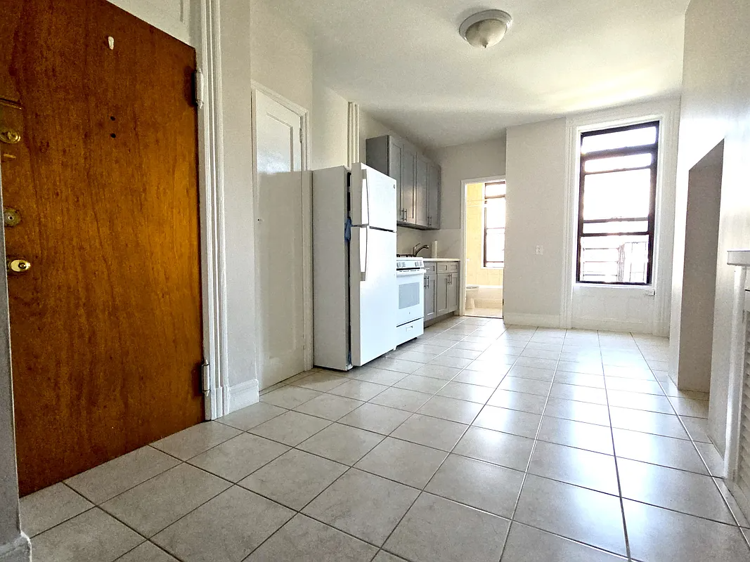 kitchen with tile floor, window, pantry
