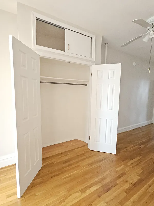 open closet with storage on top