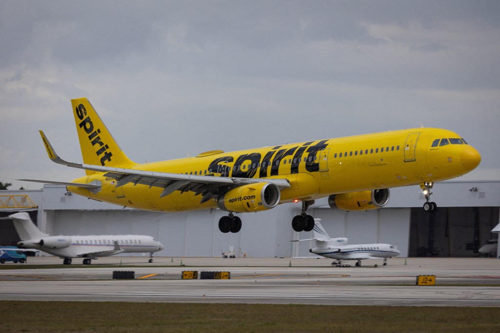 A yellow Spirit Airlines flight arrives at Fort Lauderdale-Hollywood International Airport.