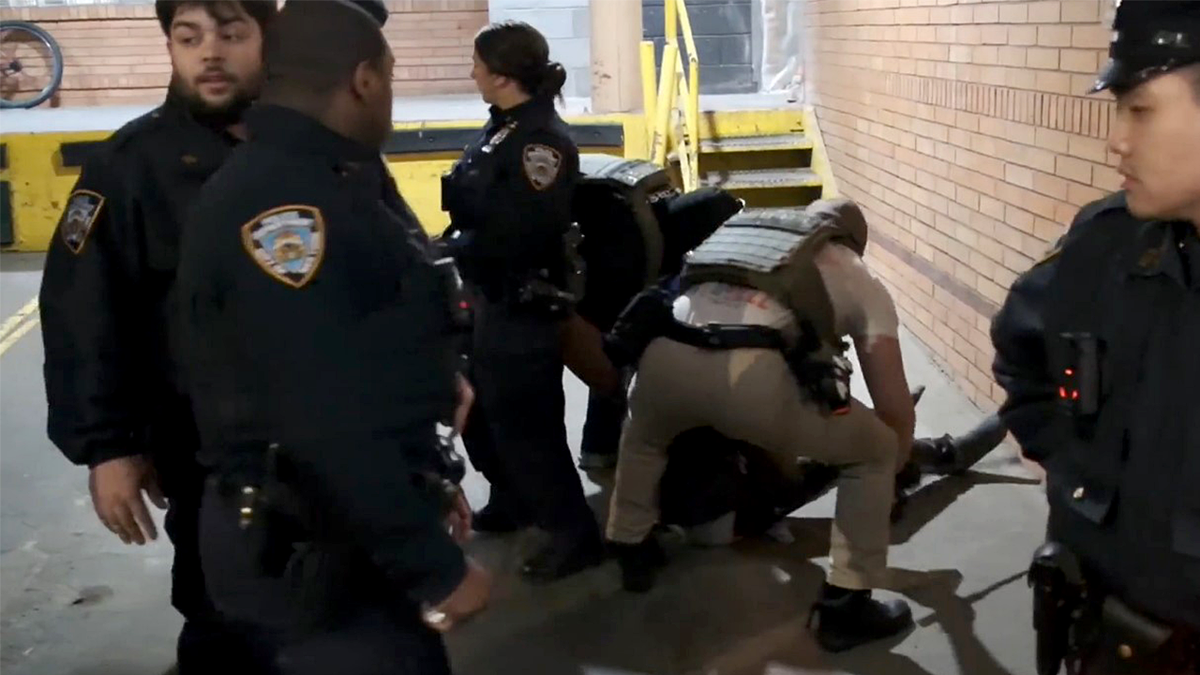 ICE agents dragging a migrant from a hospital