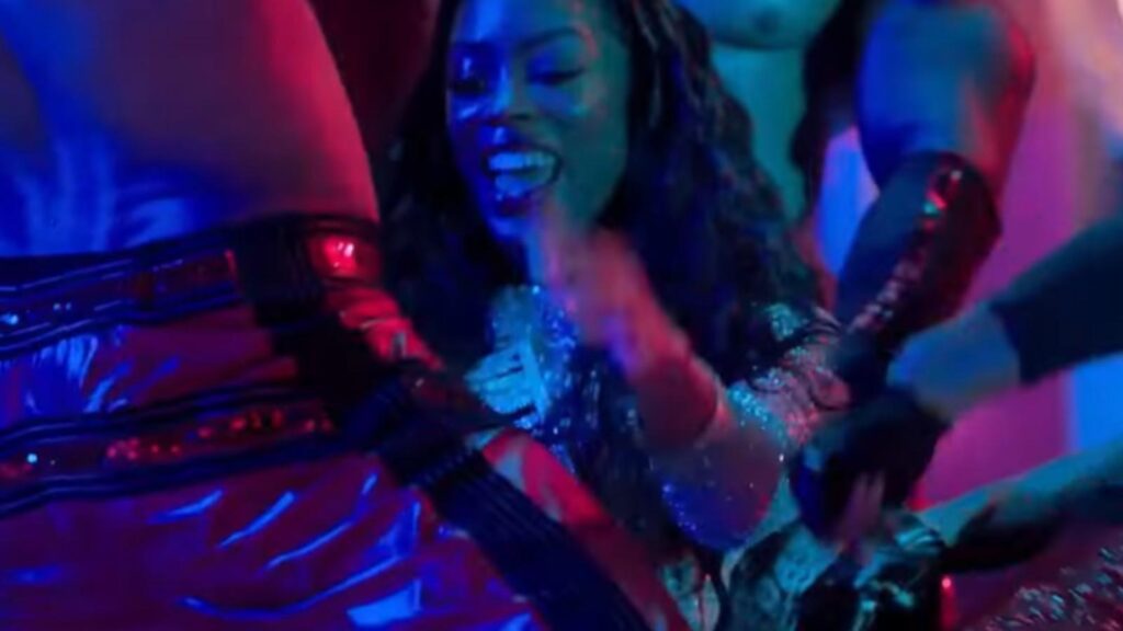 Candace Maxwell as DJ Dime dancing in neon club scene, from All The Queens Men Season 4