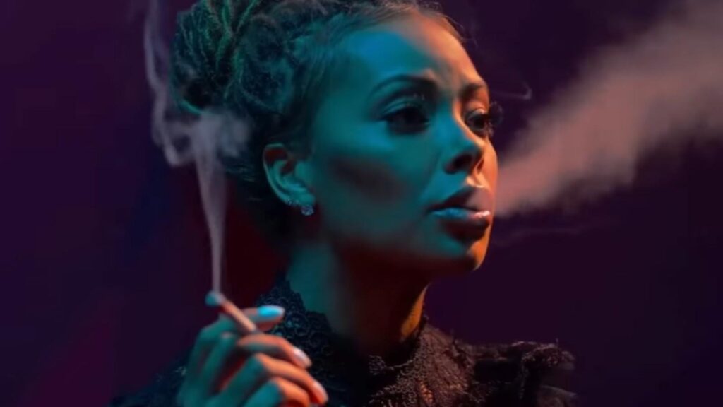 Eva Marcille as Marilyn Madam DeVille smoking in club lighting, from All The Queens Men Season 4