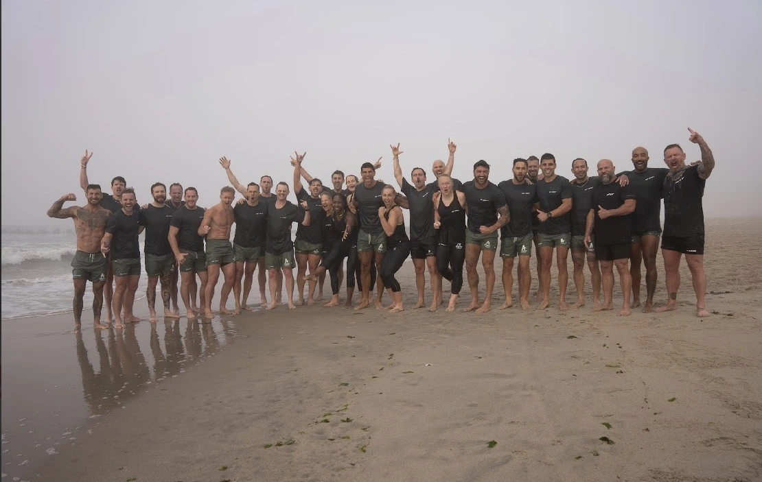 people pose for a photo on the beach