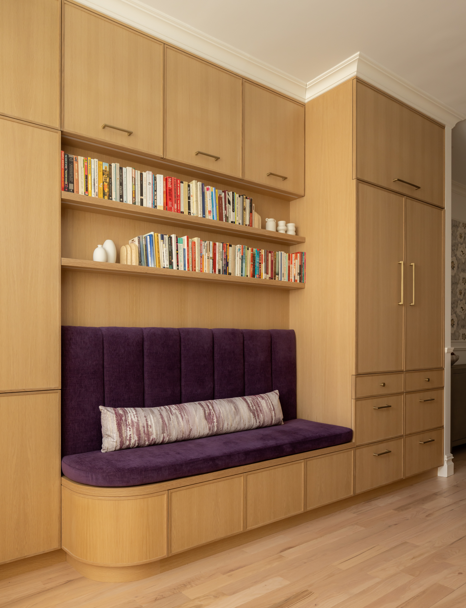 WALL OF CABINETRY WITH CURVED SEAT