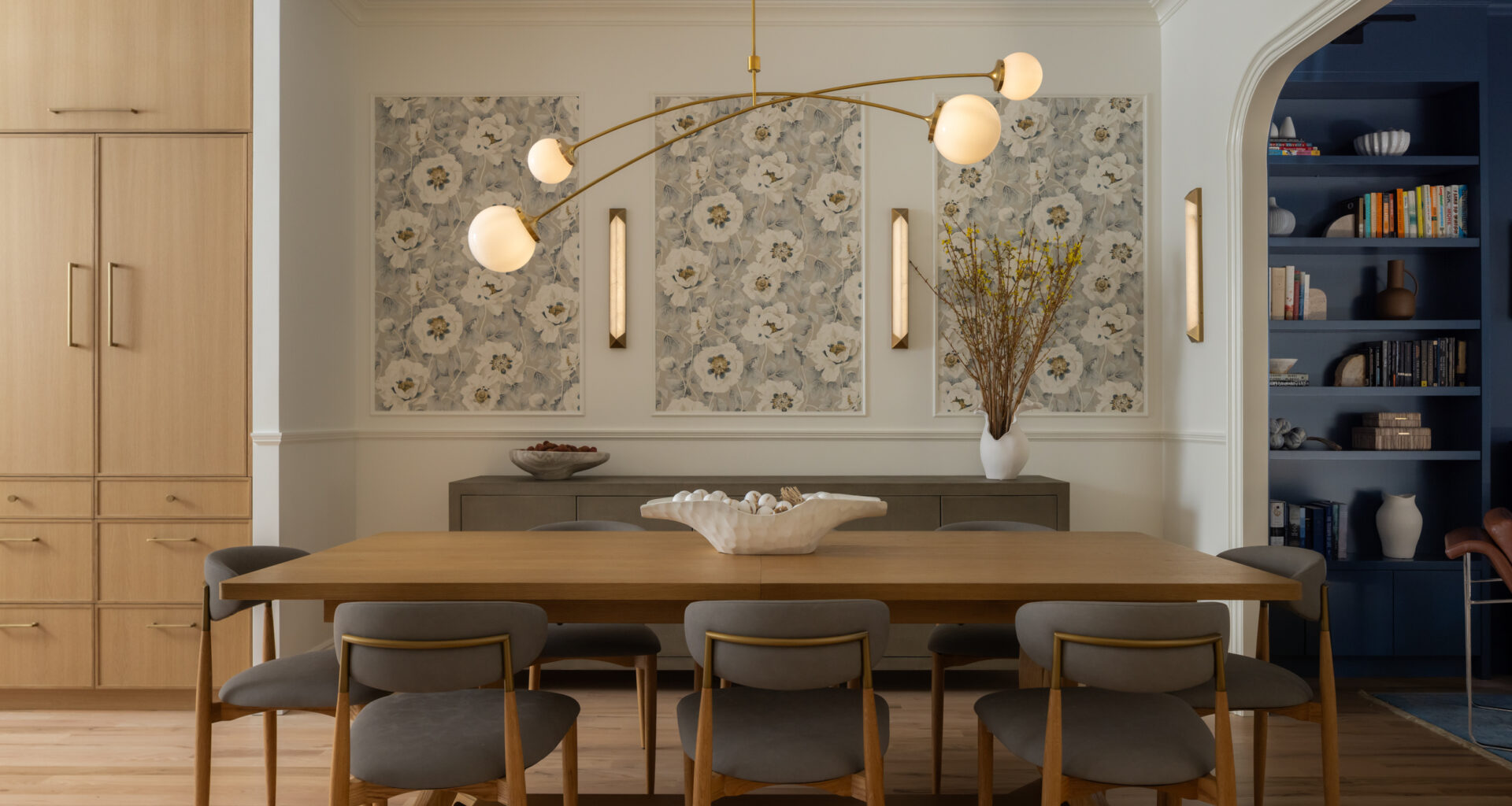 DINING ROOM with modern chandelier and pale wood table