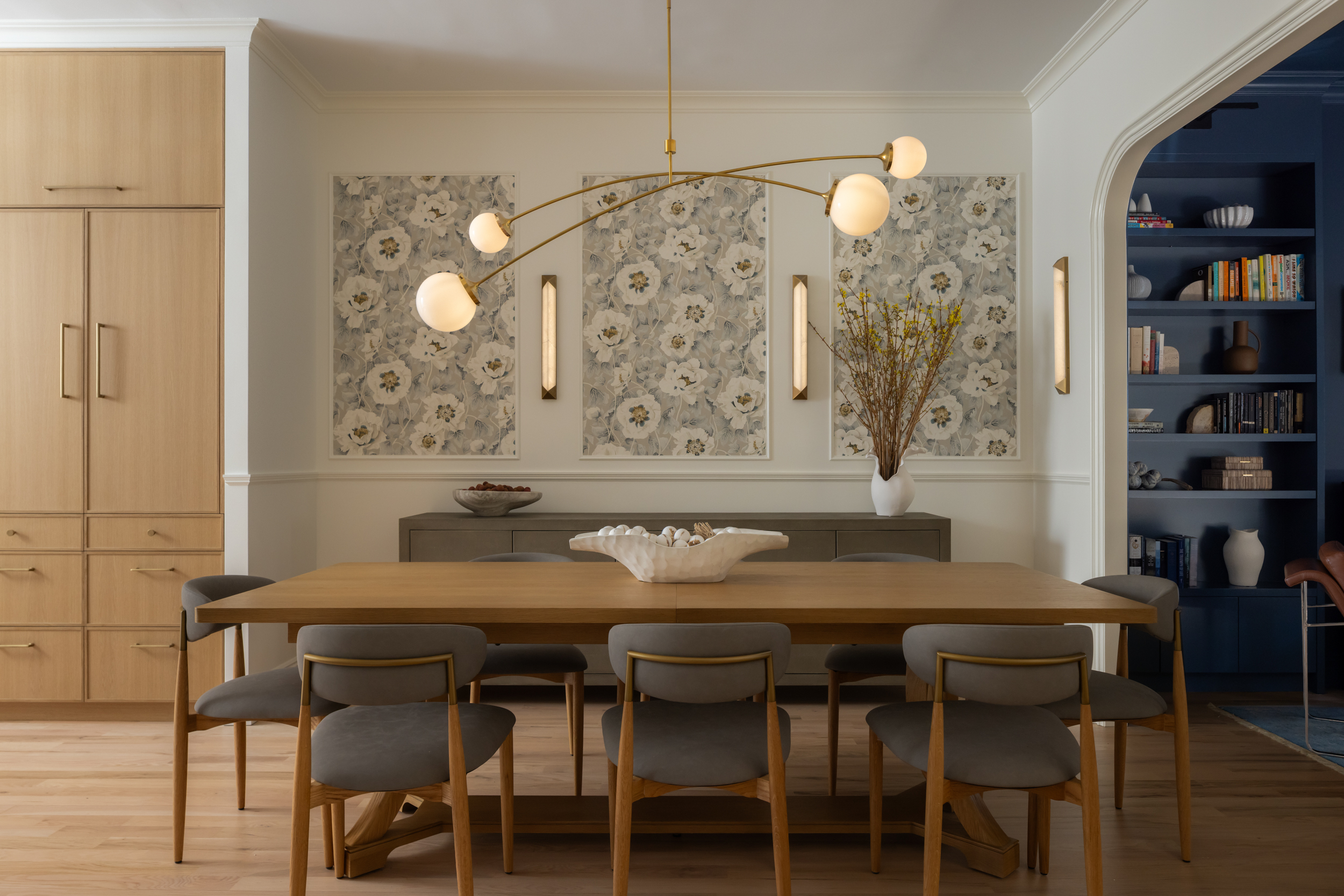 DINING ROOM with modern chandelier and pale wood table
