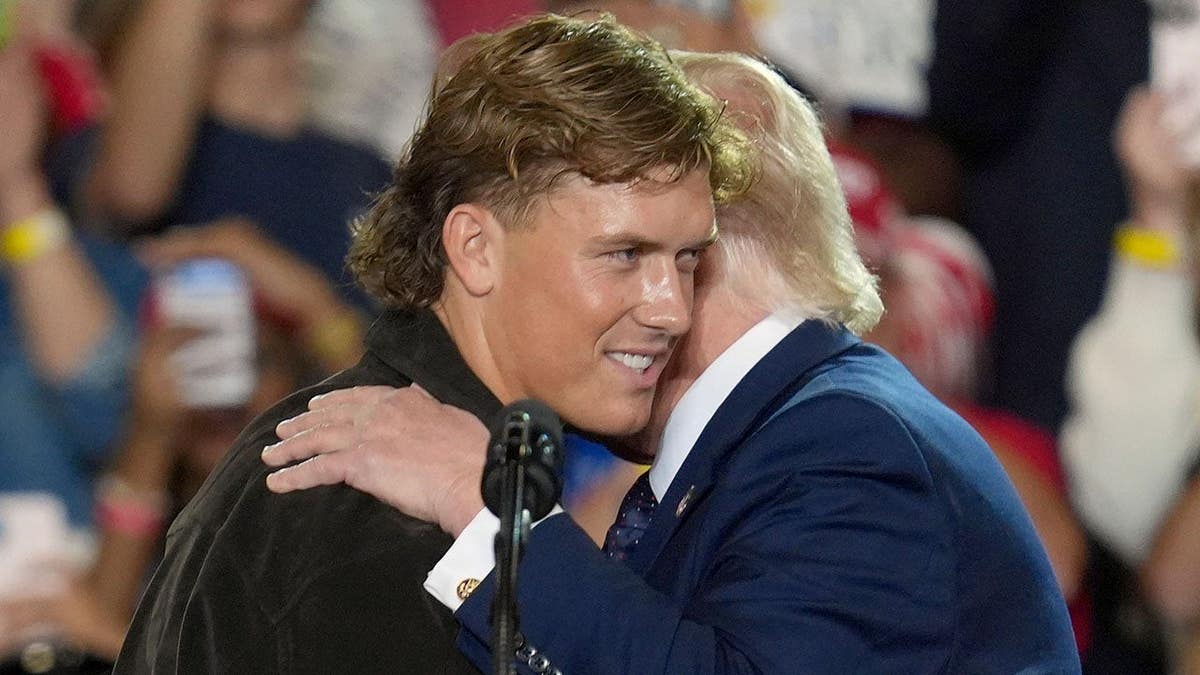 NFL quarterback Jaxson Dart hugging President Donald Trump at an event in Suffern, New York