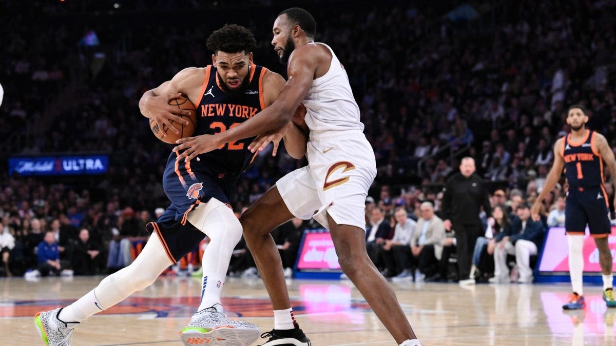 New York Knicks center Karl-Anthony Towns driving to the basket against Cleveland Cavaliers forward Evan Mobley at Madison Square Garden