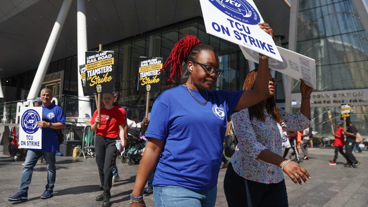 Long Island Rail Road workers walking on picket line outside Penn Station in New York