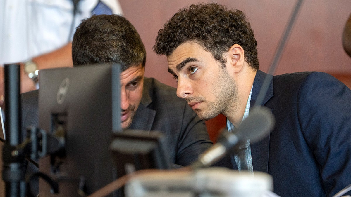 Luigi Mangione standing in a courtroom at an evidence suppression hearing