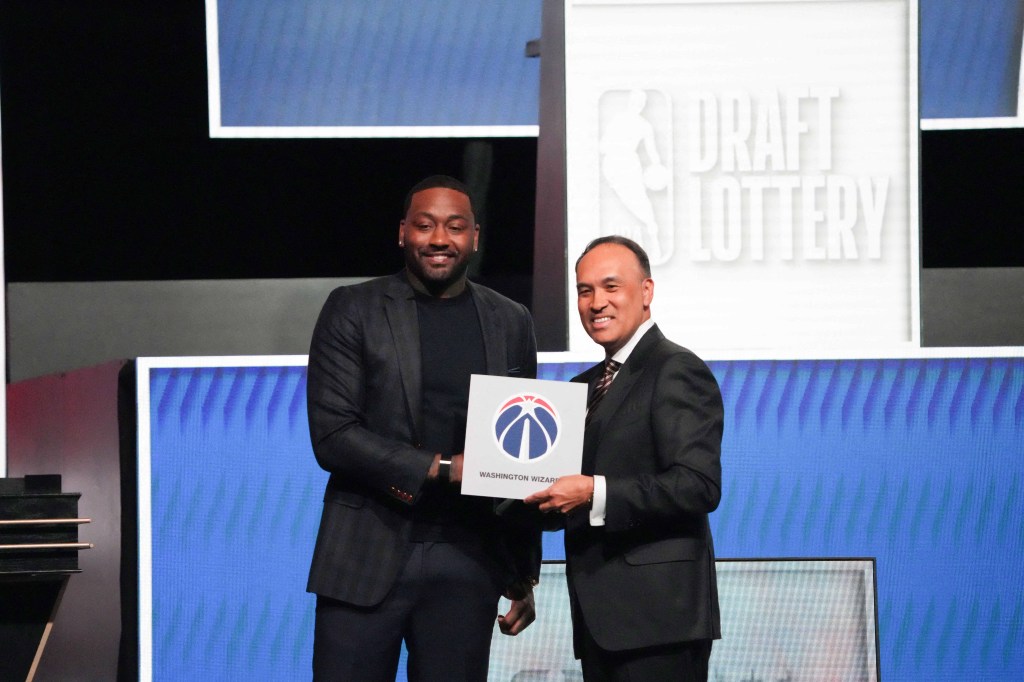NBA deputy commissioner Mark Tatum (r.) poses with Wizards great John Wall (l.) after Washington wins the NBA draft lottery in Chicago on May 10, 2026.