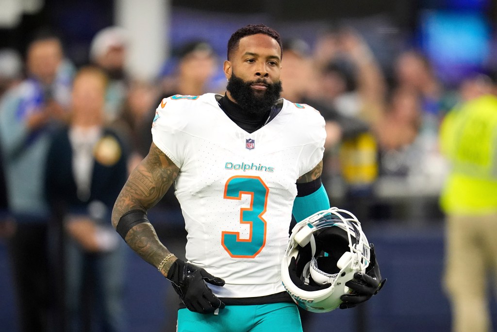 Odell Beckham Jr. with his helmet off, wearing a white Miami Dolphins jersey with the number 3.