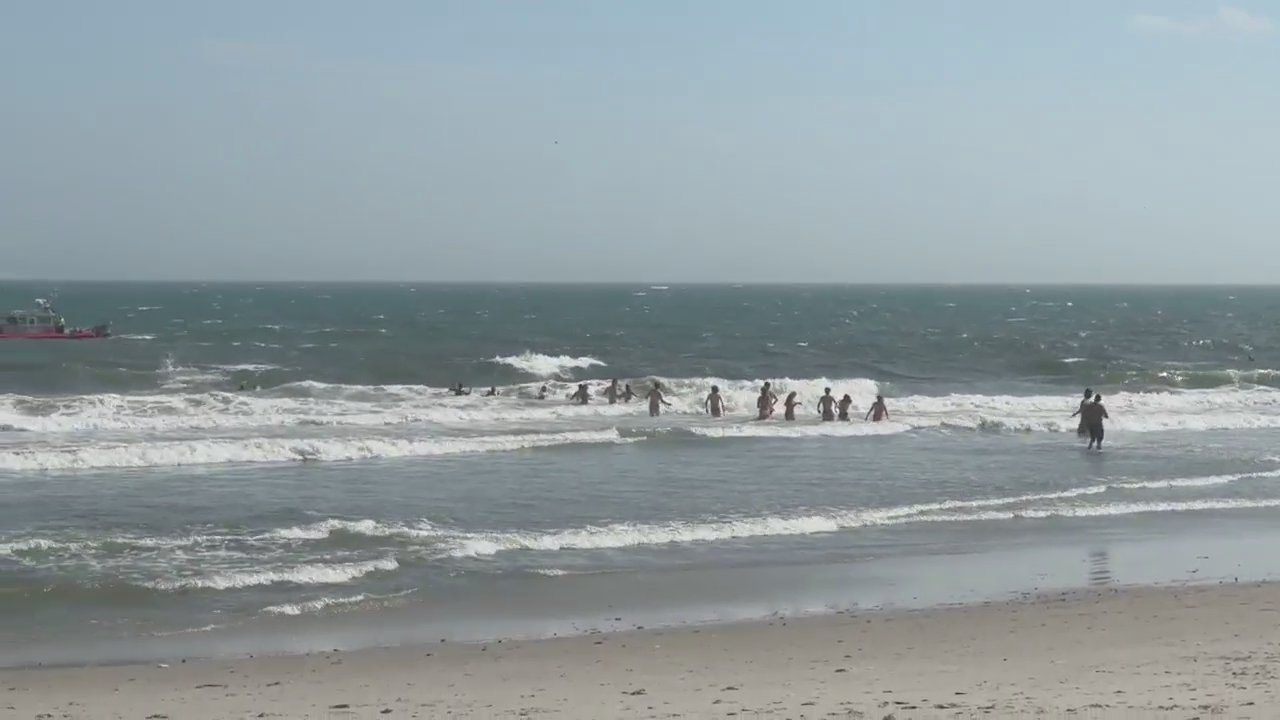 Teenagers taking part in senior cut day tried to rescue their friend forming human chains in the surf off Beach 73rd Street. 