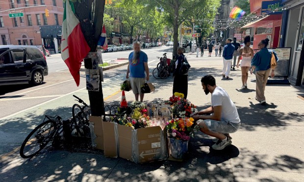 Friends and neighbors visit a memorial for the crash victims on Amsterdam Ave. near West 109th St. on Sunday.