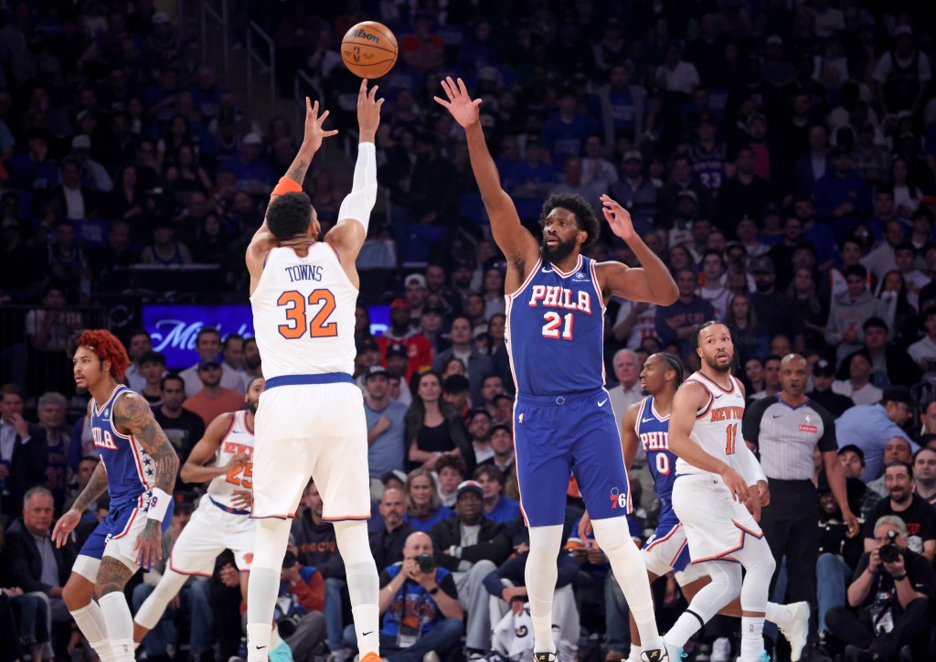 New York Knicks center Karl-Anthony Towns #32 puts up a shot over Philadelphia 76ers center Joel Embiid #21 in the first quarter of an NBA playoff game.