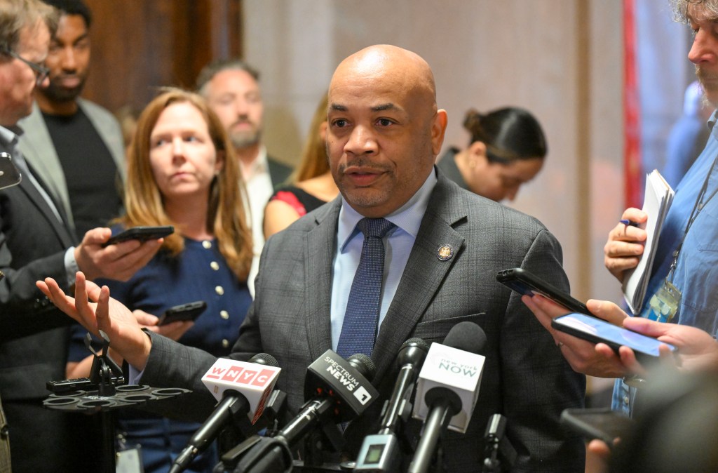 New York Assembly Speaker Carl Heastie talks with reporters.