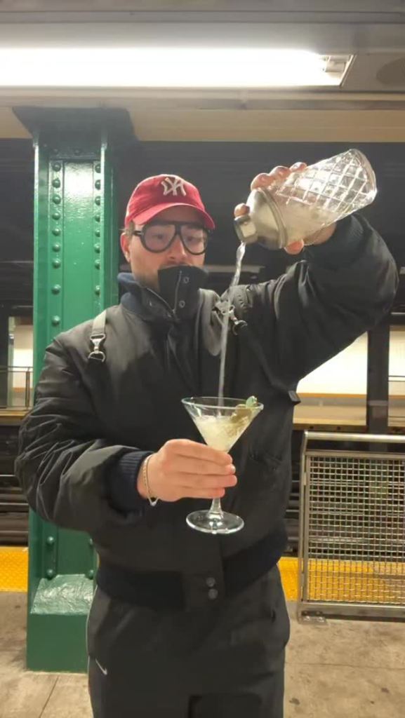 New York City influencer Louie Fevola making a martini while waiting for the subway