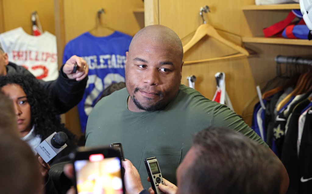 New York Giants defensive tackle Dexter Lawrence II #97 speaking to media in front of his locker after practice.