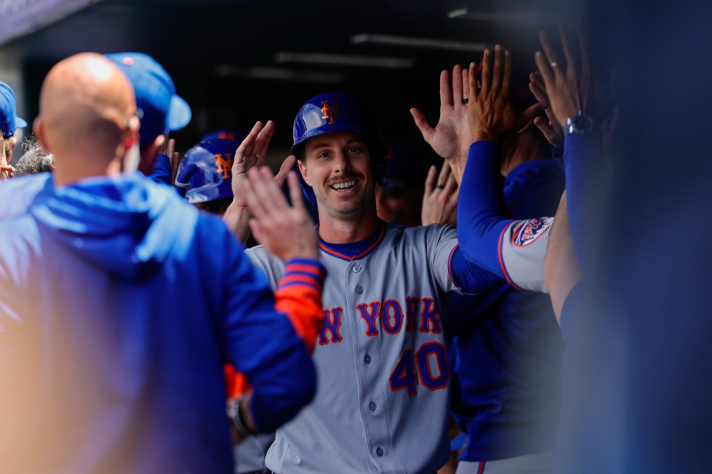 New York Mets right fielder Austin Slater (40) celebrates with teammates in the dugout.