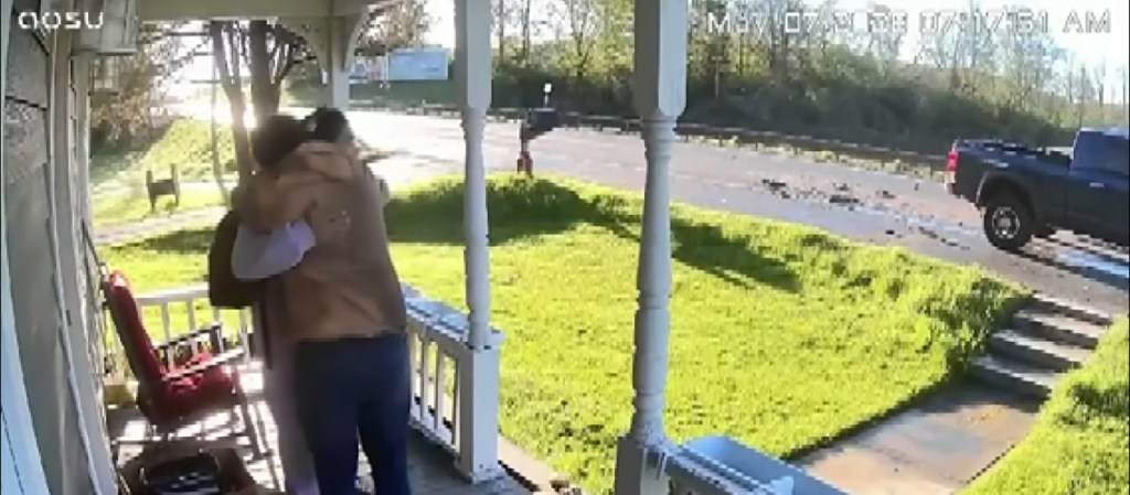 An older man and his teenage son share a hug