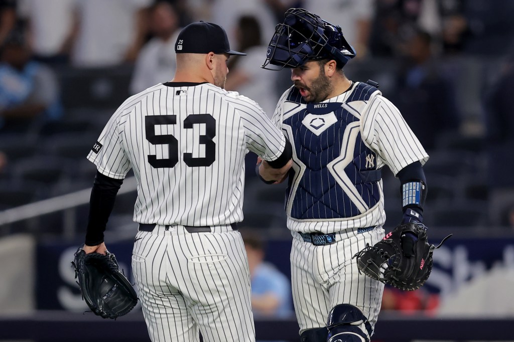 New York Yankees pitcher David Bednar and catcher Austin Wells celebrate a win.