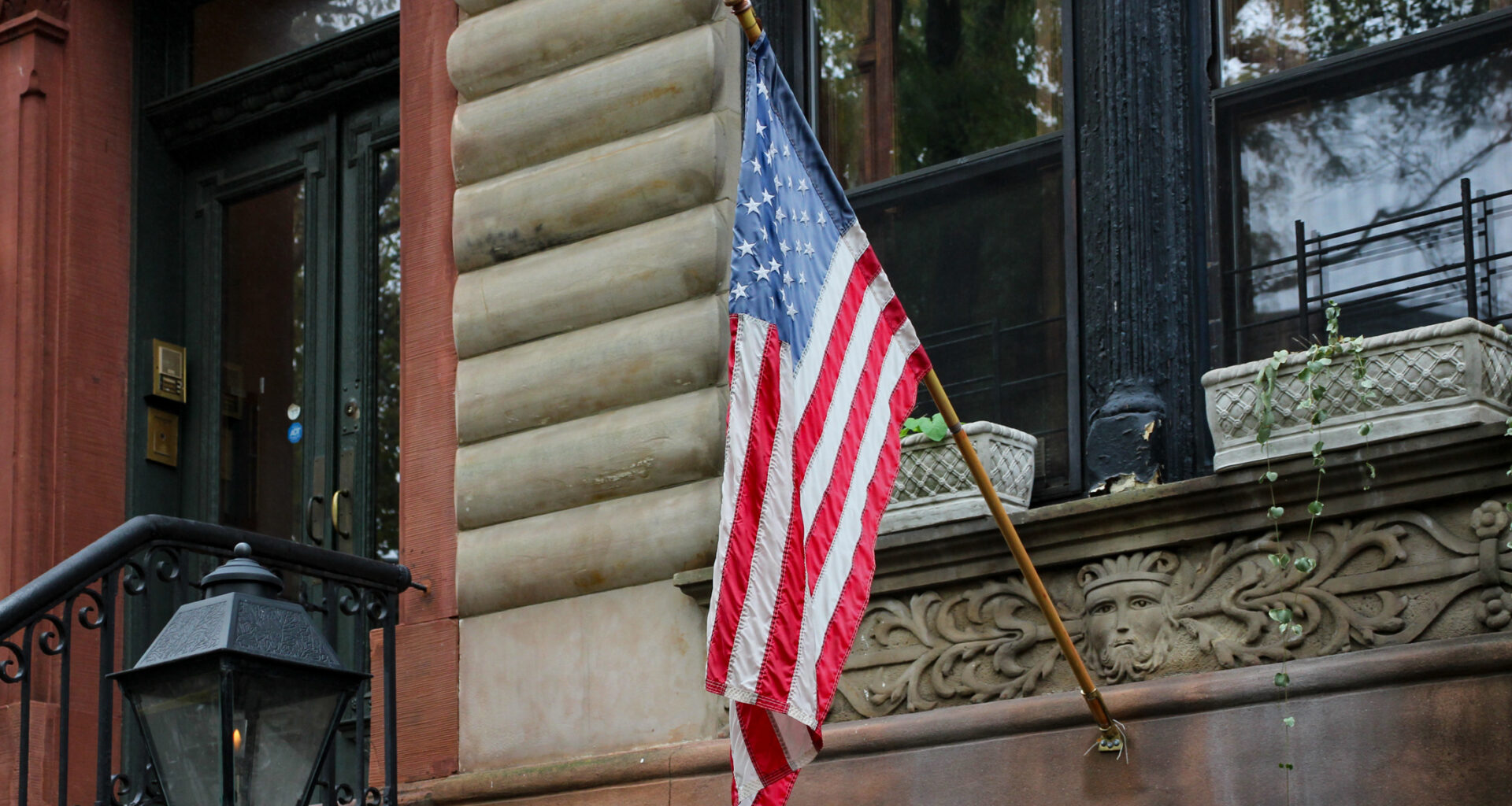 flag on a brownstone in park slope