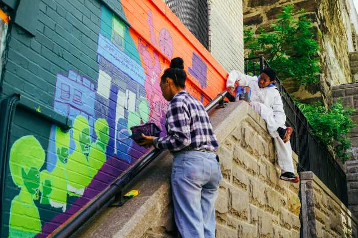  residents, artists, youth, and community members help paint "Unity in Our Community."