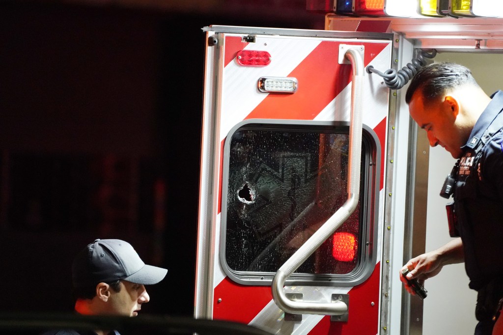 Police at the scene where an FDNY ambulance was struck by a bullet that traveled through the entire ambulance.