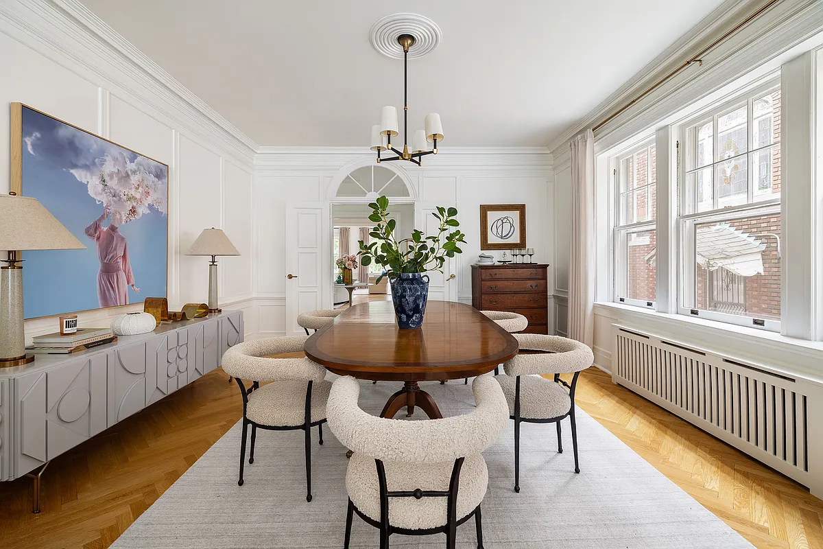 a dining room with wood floor, arched doorway
