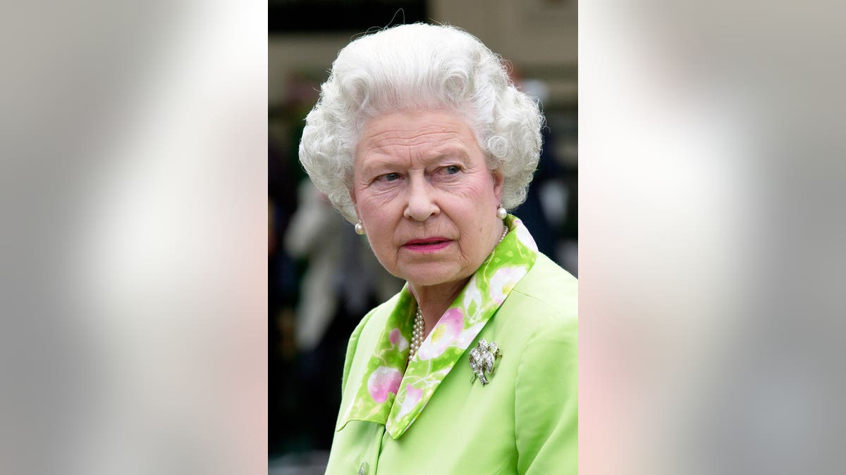 Queen Elizabeth II wearing a light green dress at the Chelsea Flower Show