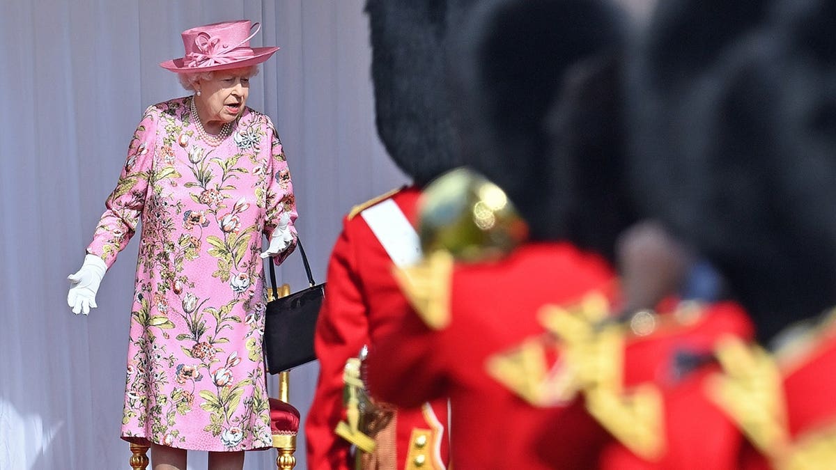 Queen Elizabeth II standing outside Windsor Castle awaiting U.S. President Joe Biden and First Lady Jill Biden