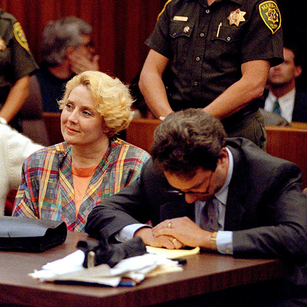 Betty Broderick smiling as her attorney, Jack Earley, reacts differently to the verdict.