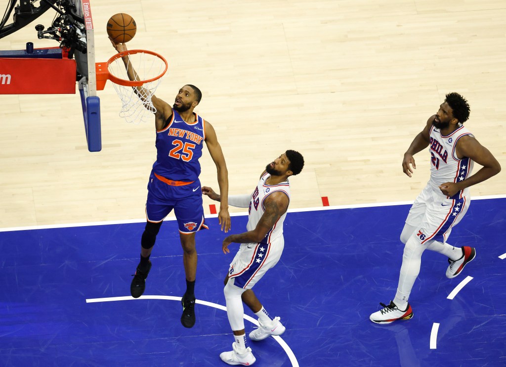New York Knicks guard Mikal Bridges (25) shoots in front of Philadelphia 76ers forward Paul George (8) during an NBA Playoffs game.
