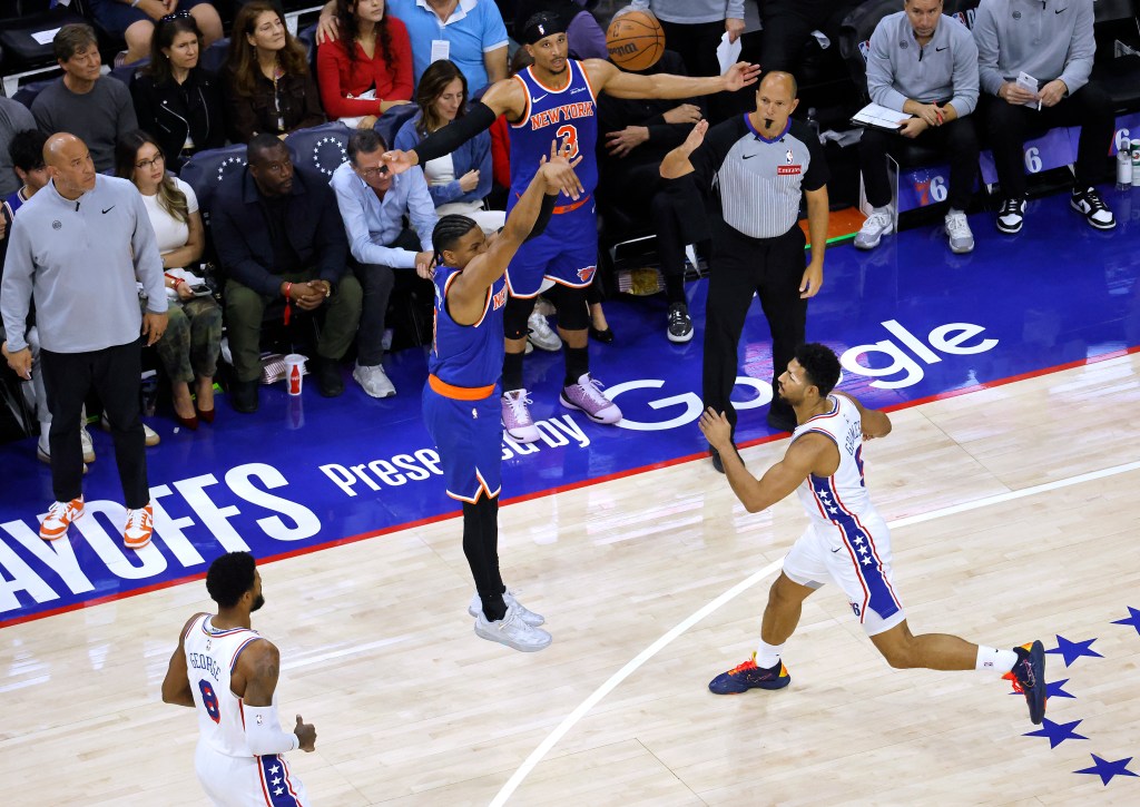 New York Knicks guard Miles McBride (2) shoots a three-point shot over Philadelphia 76ers guard Quentin Grimes (5).