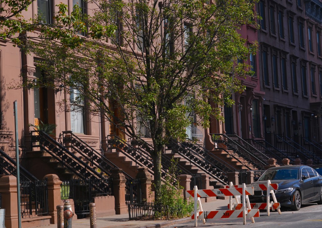 A Manhattan grand jury has indicted 18 people and three companies for allegedly orchestrating a years-long conspiracy to steal the deed to a Harlem brownstone.