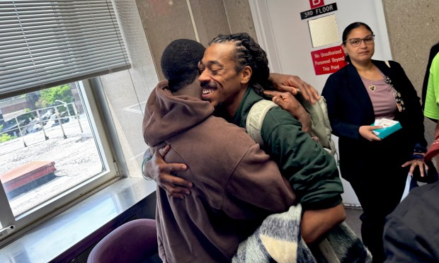 Robert Williams' brother, Pharris Williams, right, hugs shooting survivor Jonathan Cato at Queens Criminal Court on Friday, May 22, 2026 after the sentencing of Richard Swygert. (Rebecca White / New York Daily News)